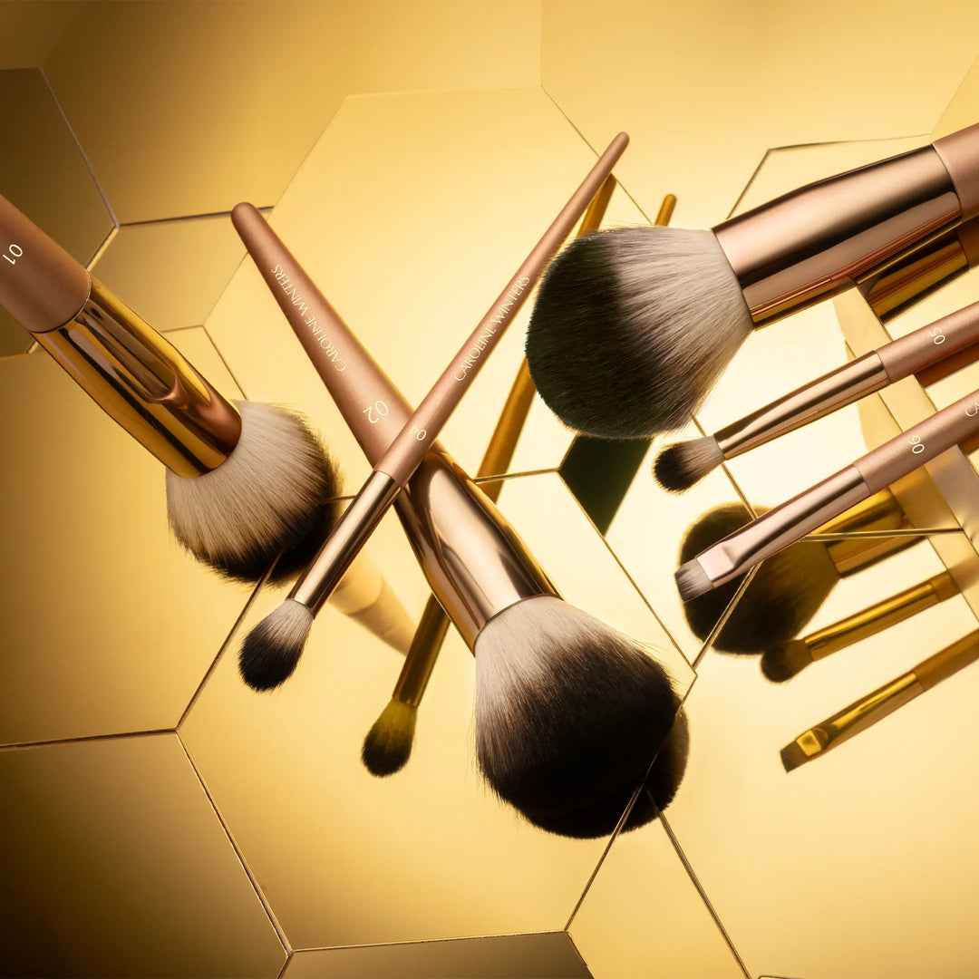 Makeup brushes with gold hexagonal background